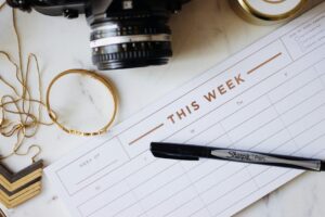 wedding-planning-guide-checklist-with-a-camera-and-pen-on-a-table