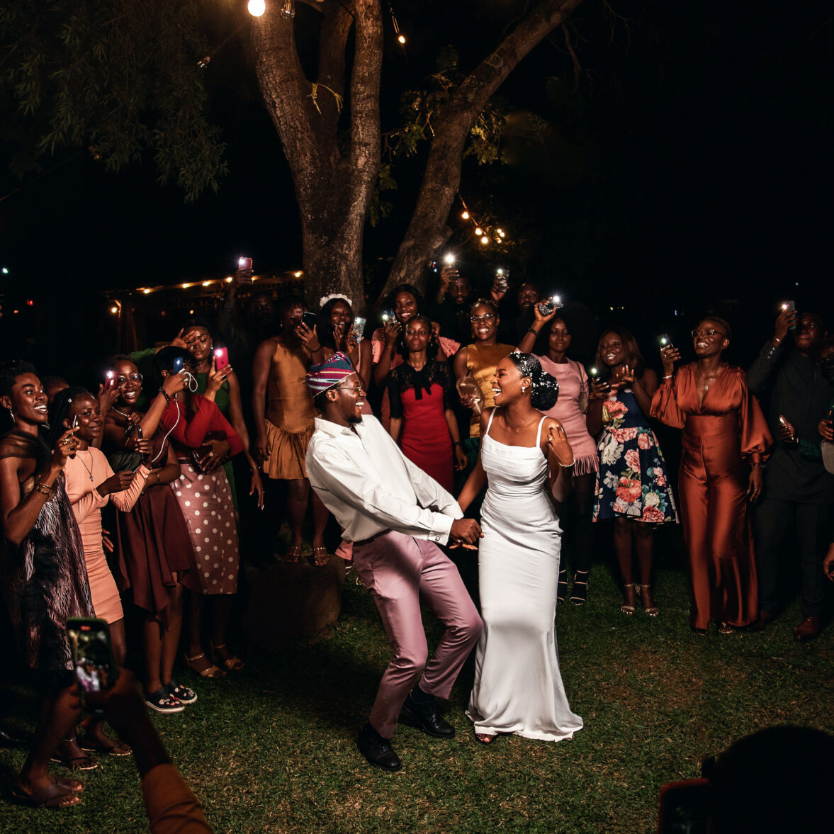 african-couple-celebrating-their-marriage-with-friends-outdoors-at-night