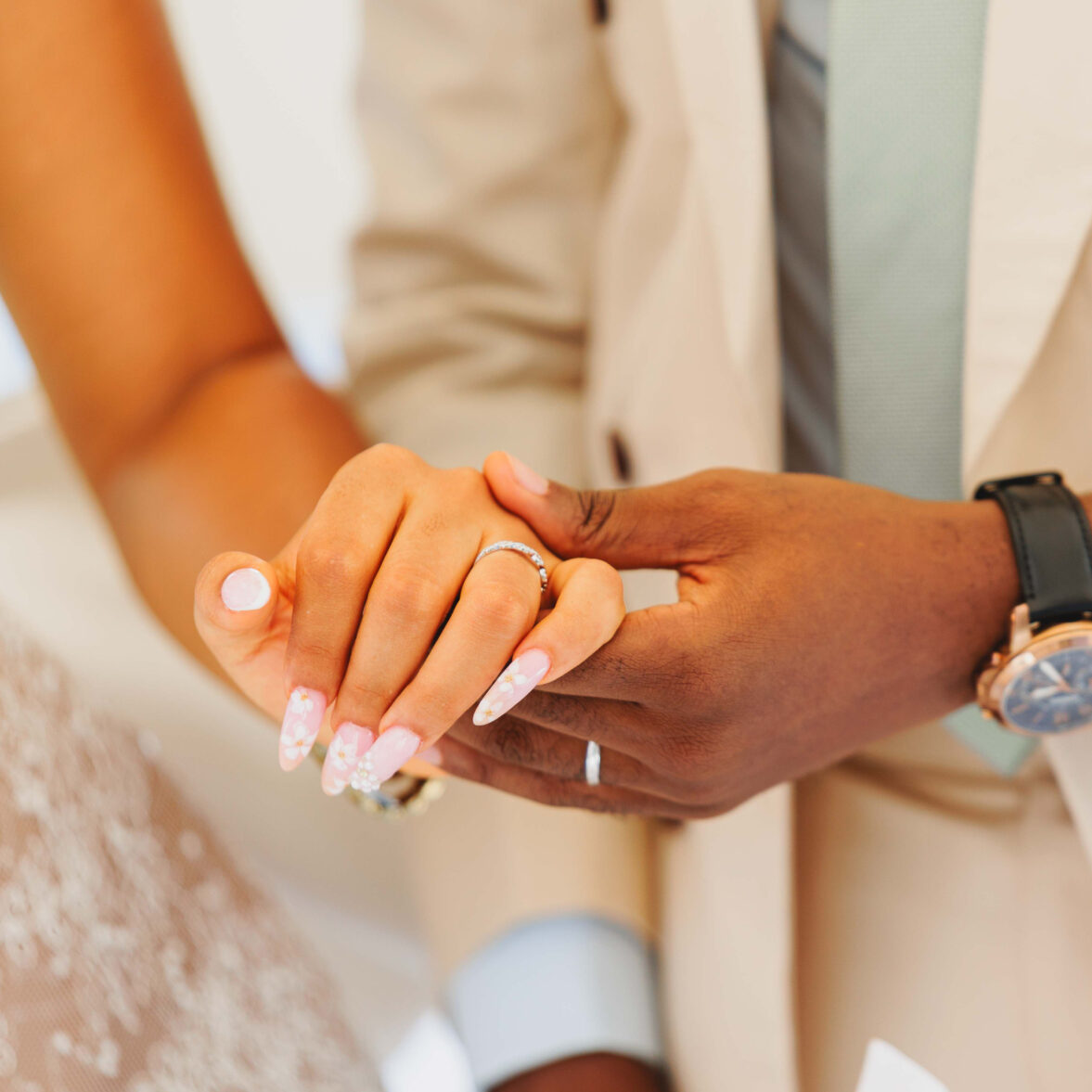 married-couple-holding-hands-with-the-focus-on-the-hands-and-the-rings