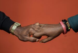engaged-couple-holding-hands-interlocked-fingers